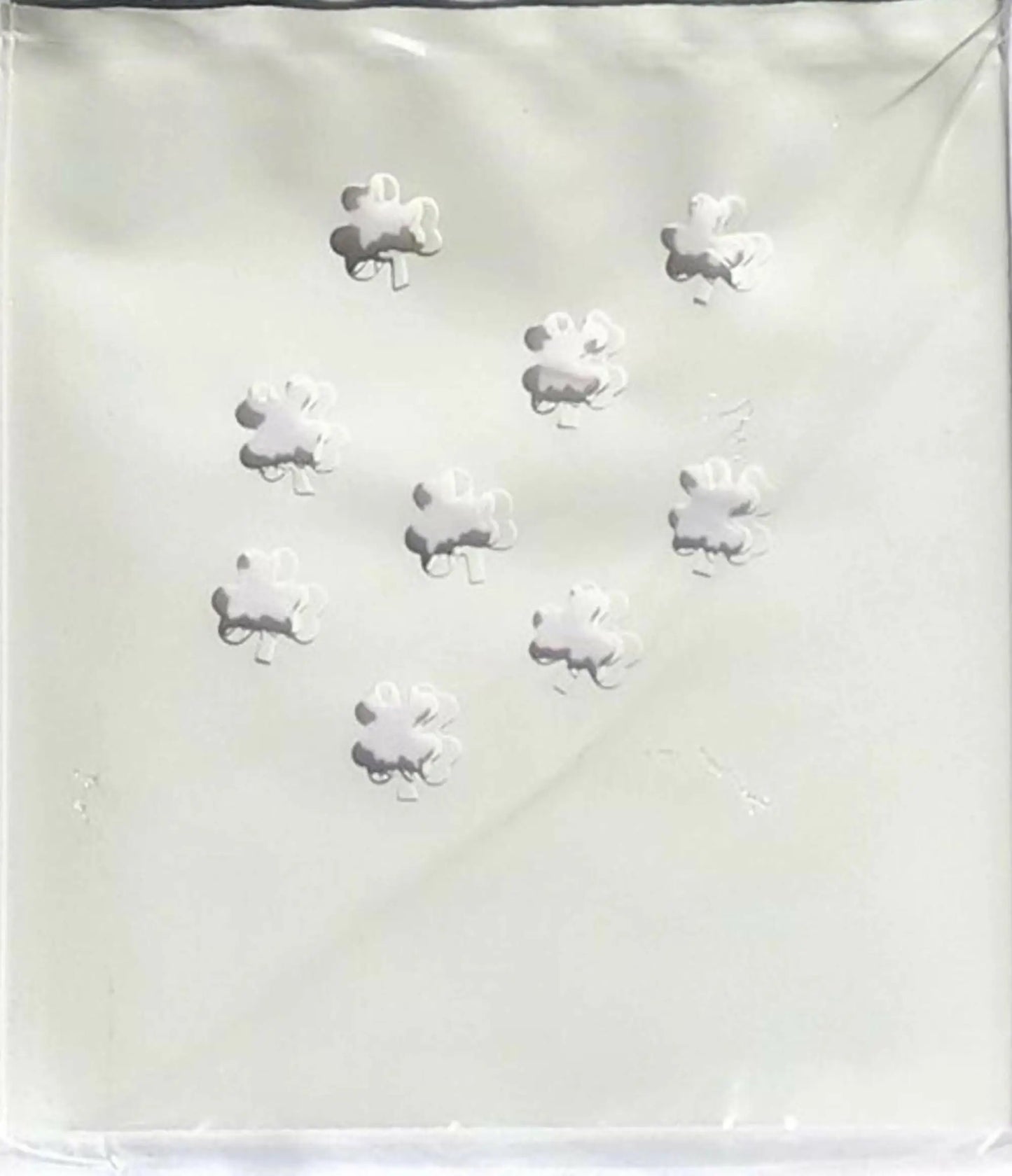 Nine white puzzle-piece candies from Classic LUMINARY SET, perfect for luminarias bags