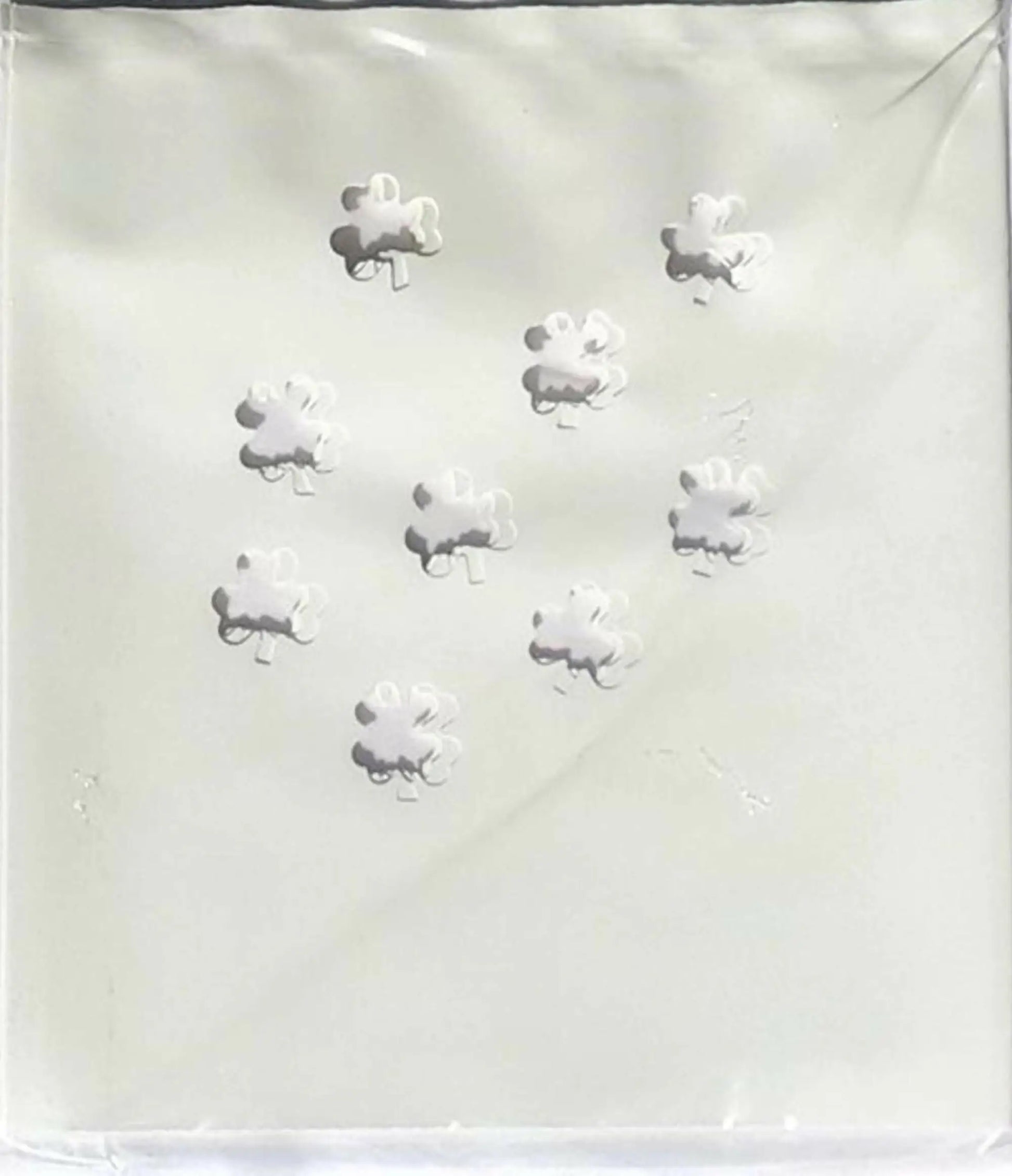 Nine white puzzle-piece candies from Classic LUMINARY SET, perfect for luminarias bags
