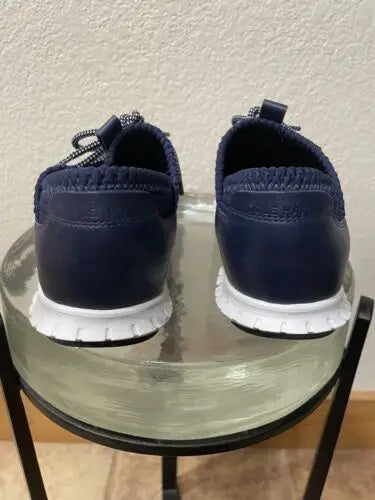 Navy blue Cole Haan Zerogrand women’s sneakers displayed on a white background
