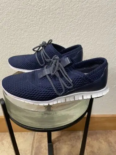Pair of navy blue knit Cole Haan Zerogrand women’s sneakers for stylish comfort