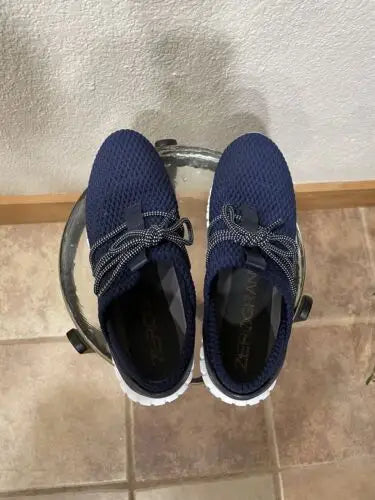 Pair of navy blue Cole Haan Zerogrand women’s sneakers on a white background