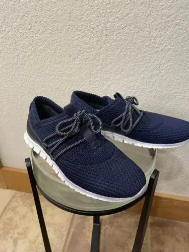 Pair of Navy Blue Cole Haan Zerogrand Women’s Sneakers on display