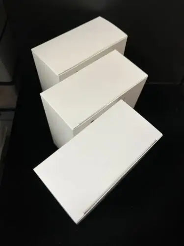 Three white rectangular boxes from the D&D Onslaught Launch Kit Sealed collection