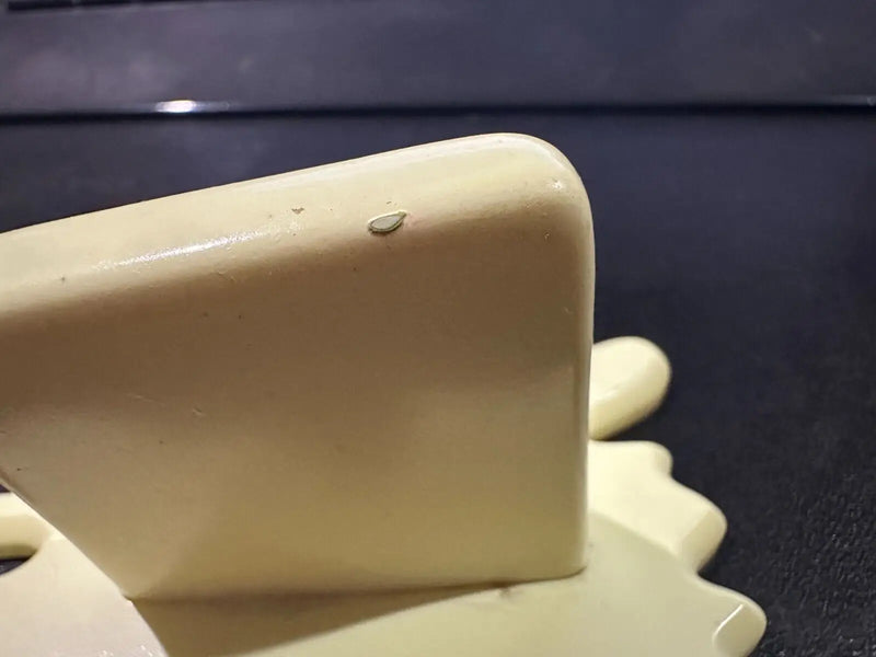 Cream-colored glossy decorative object for the Butter Barrage accessory from Diamond Select