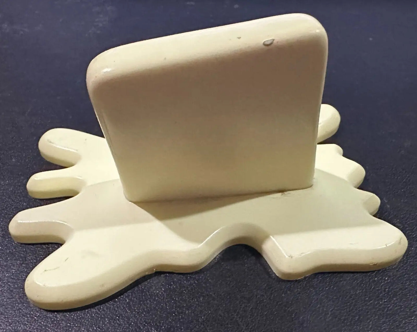 Cream-colored spilled-liquid phone stand for the Butter Barrage Accessory from Plants vs Zombies