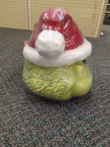 Ceramic Cookie Jar featuring Grinch head with Santa hat and sleigh bell bistro design