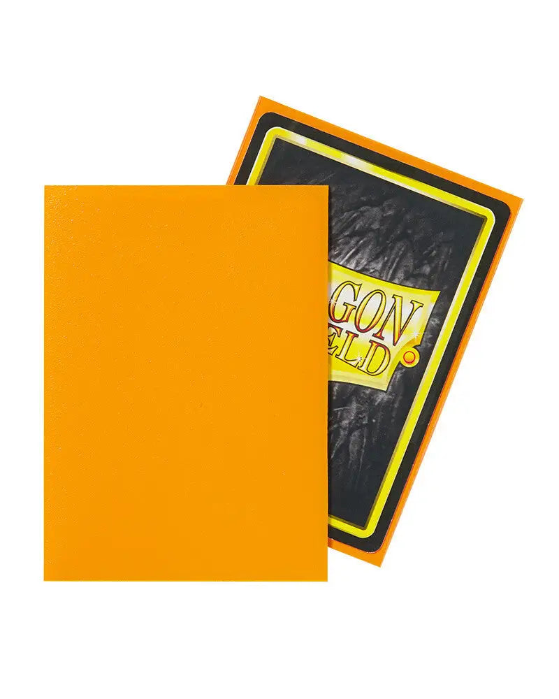 Bright orange Dragon Shield sleeve overlapping darker card, ideal for trading cards