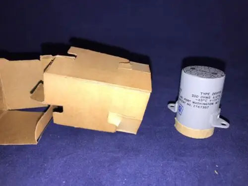 Gray cylindrical electrical relay component with mounting tabs from FILTORS INC stock w box
