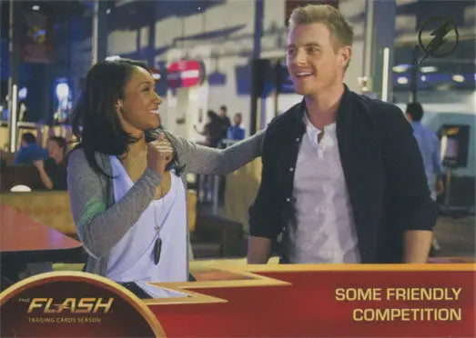 Trading card of two people smiling on a city street for Flash Season 1 Gold Logo Parallel Chase Card