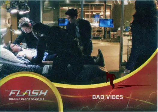Trading card of The Flash in medical emergency, featuring Scarlet Speedster Deco Red Foil
