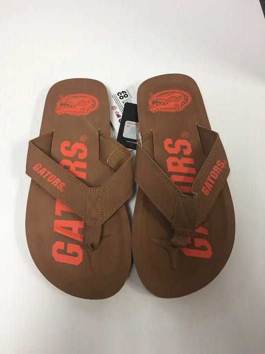 Brown flip-flops with red Gators branding, perfect for showcasing team logo display