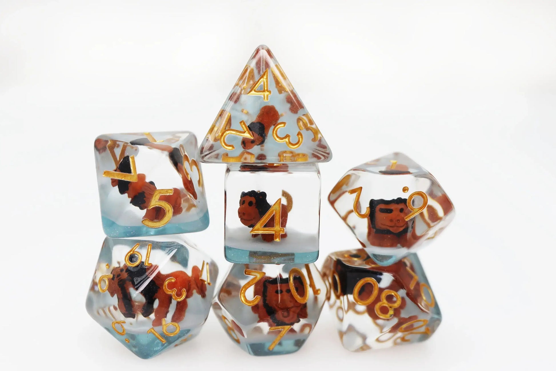 Foam Brain RPG Dice Set with clear resin, blue gradient base, gold numbers, encasing brown figures