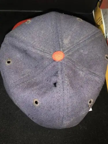 Worn blue California Angels cap with ventilation holes and orange button, autographed