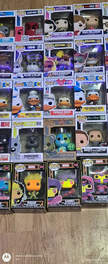 Colorful Funko Pops collection displayed alongside trading cards and baseball cards