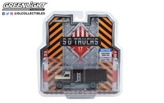 Die-cast model truck in packaging featuring SD Trucks branding and hazard stripes