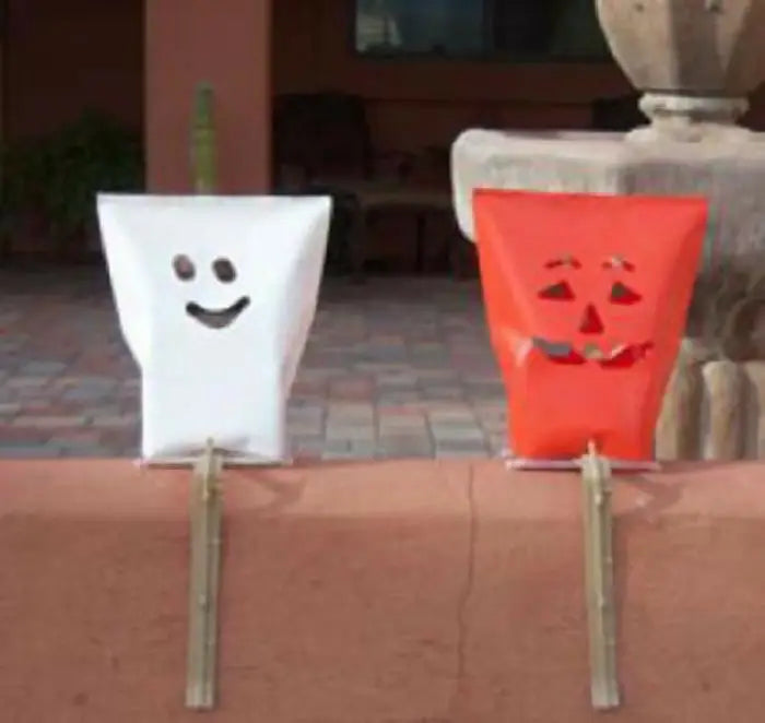 Decorative white ghost and red orange pumpkin bags on sticks from Halloween Electric Luminary Sets