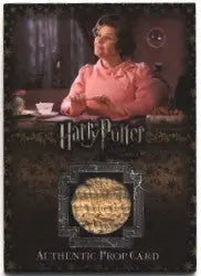 Pink knitted sweater worn by a person with Harry Potter and the Order of the Phoenix prop card
