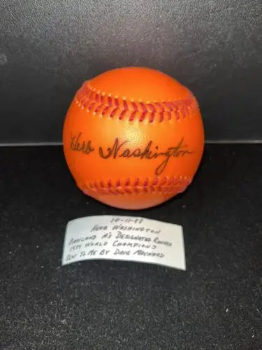 Autographed orange baseball from Herb Washington, perfect for baseball cards collectors