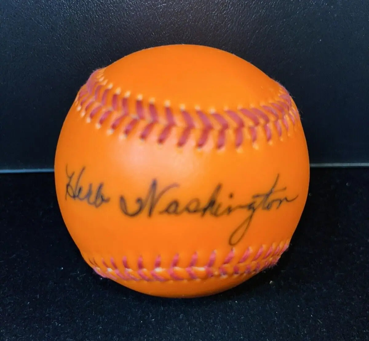 Orange baseball signed by Herb Washington, ideal for baseball cards collectors