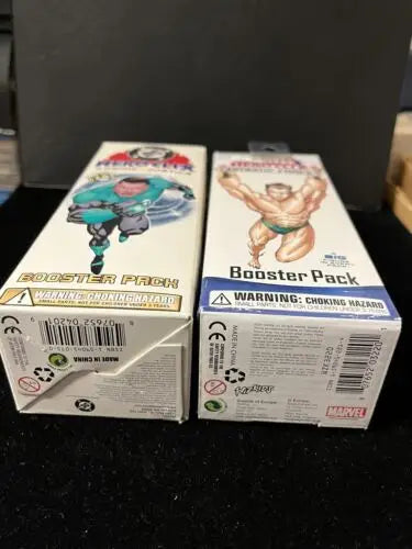 Two HeroClix booster packs from the Marvel Fantastic Forces and DC Cosmic Justice lot