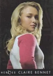 Portrait of a young blonde woman in a white and pink top with Heroes Foil Chase trading cards