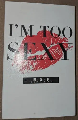White book with red lip print and bold black lettering on Fred cassette single Spanish version