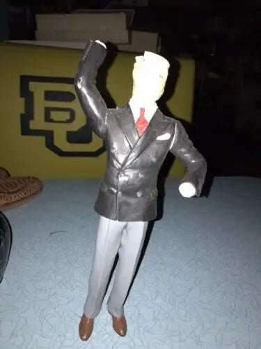 Figurine of a man in a suit with raised arm from Invisible Man Model Vinyl Kit