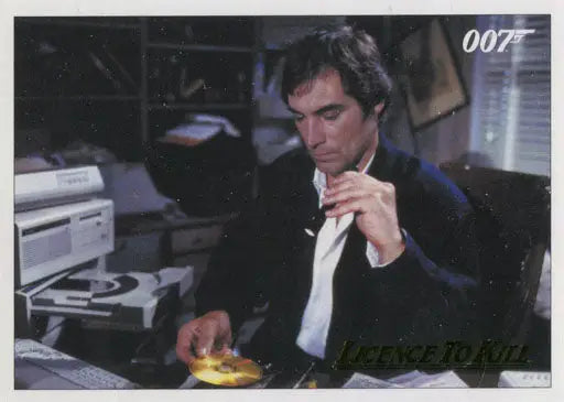 Man in dark suit at desk, contemplative, featured on Gold Parallel Chase Card trading cards