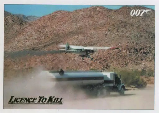 Tanker truck on desert road with plane, part of James Bond 007 Gold Parallel Chase Card
