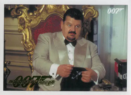 Man in a white tuxedo holding a gun seated in ornate chair from Gold Parallel trading cards