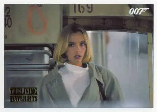 Blonde woman in white shirt and jacket gazing at James Bond Archives Gold Foil Parallel Card