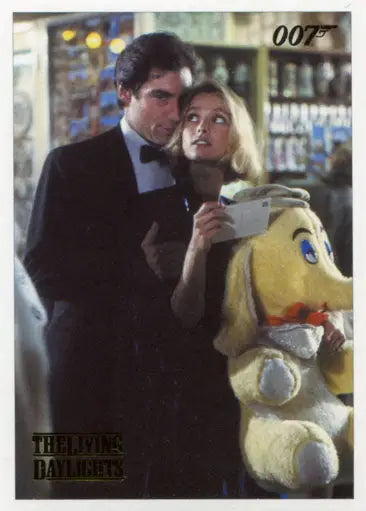 Couple in formal attire holding stuffed toy with James Bond Archives Gold Foil Parallel Card