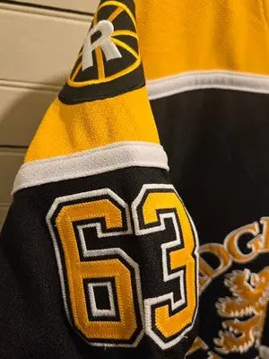 JOG Hockey Jersey Mens 48 Ridgefield Lions MacNaughton 63 Black Gold Embroidered - Apparel
