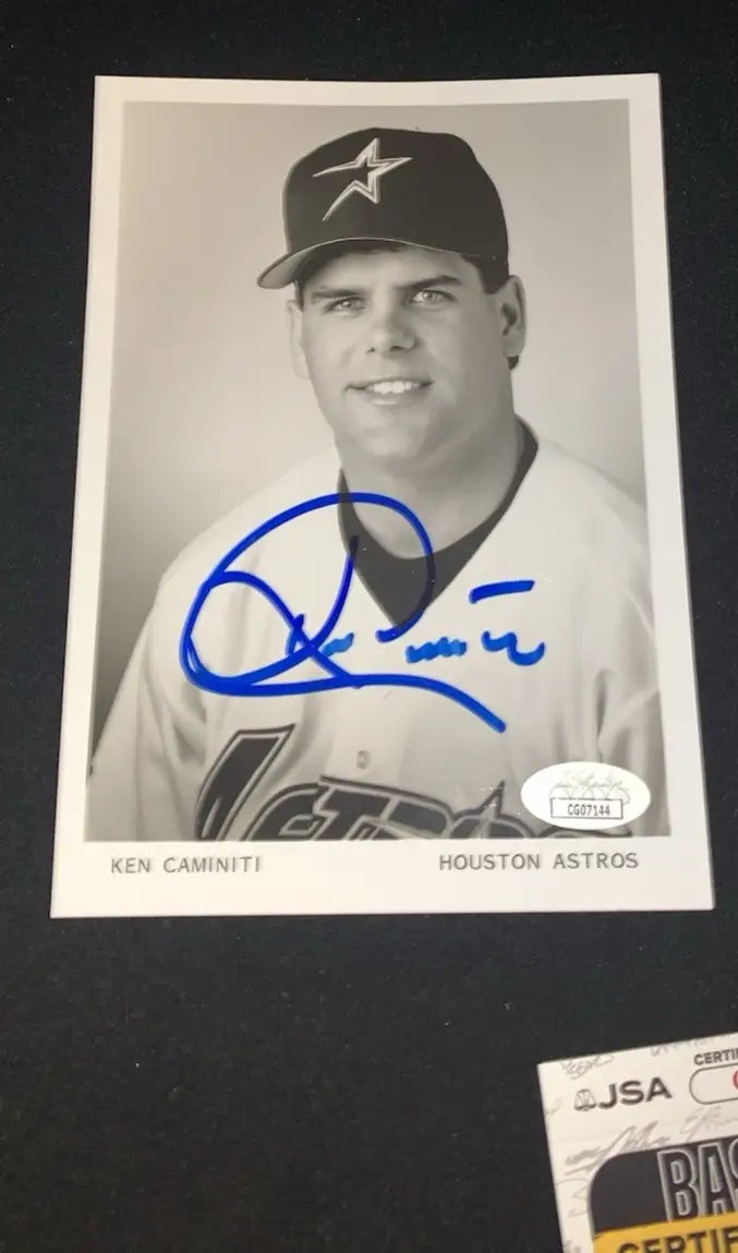 Autographed Ken Caminiti baseball card displayed on a 5x7 glossy Houston Astros team photo