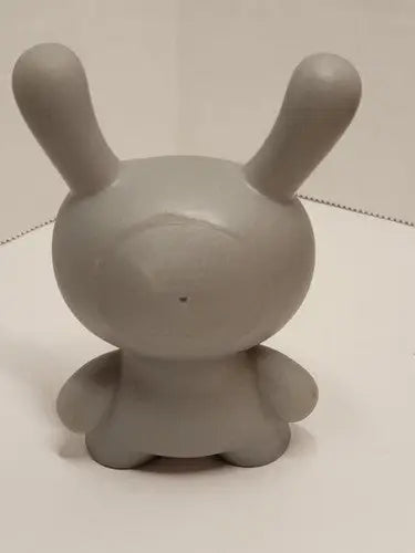 Smooth grey vinyl toy with long ears and stubby limbs from Kidrobot Red Button Dunny series