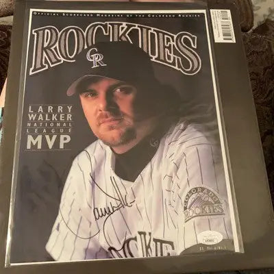 Signed Larry Walker Colorado Rockies baseball program cover featuring NL MVP autograph