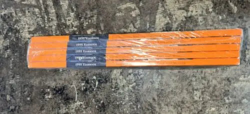 Wrapped stack of orange yearbooks for Baseball cards featuring HOF legends