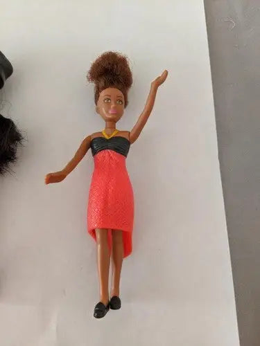 Brown-skinned doll in red and black dress from McDonald’s toys pre-owned lot