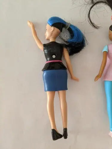 Fashion doll with blue-streaked hair from McDonald’s toys pre-owned lot on store shelf pulls