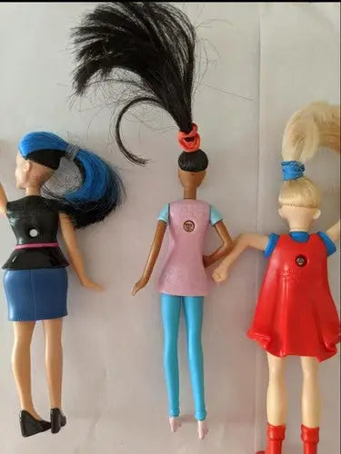 Three fashion dolls from a pre-owned lot of McDonald’s toys on store shelf pulls
