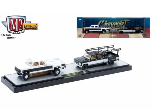 Die-cast Chevrolet Silverado trucks on display base, part of M2 Machines Auto Hauler series