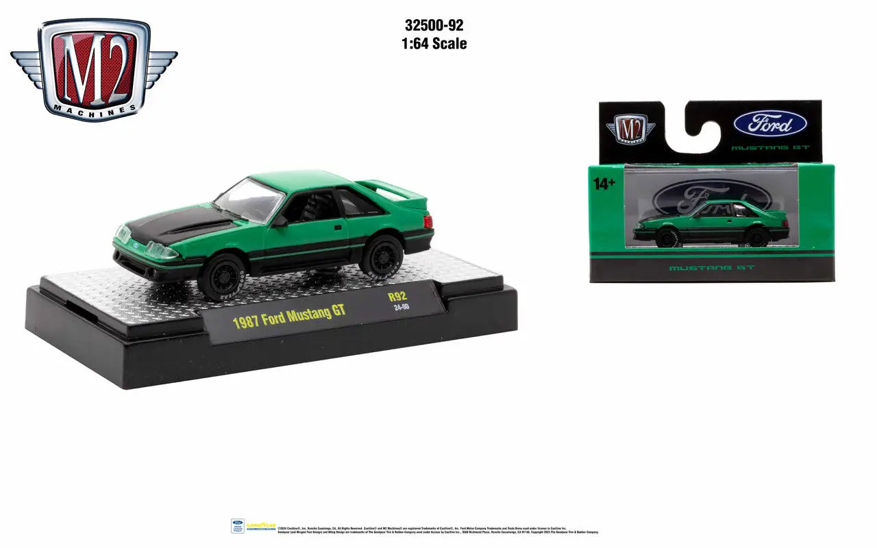 Green 1985 Ford Mustang GT die-cast model with black accents in retail packaging
