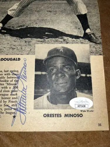 Autographed Minnie Minoso trading card and magazine page for collectors and fans