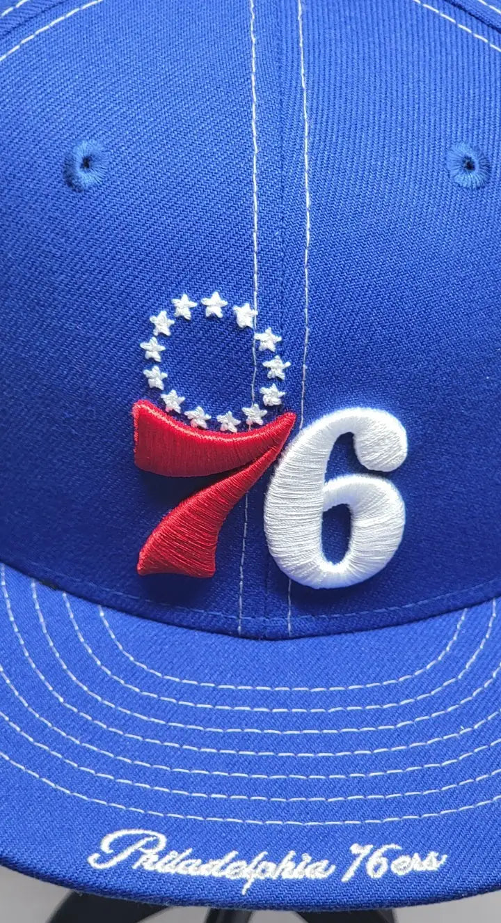 Blue Philadelphia 76ers fitted hat featuring side script for fans of the team