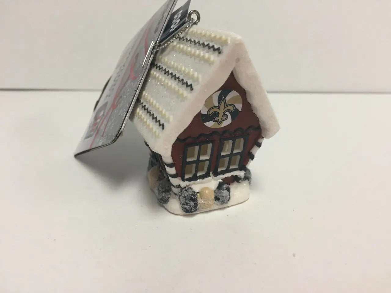 Miniature ceramic gingerbread house ornament with NFL team logo and snow-covered roof