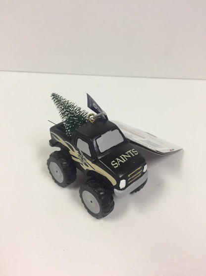 Toy monster truck ornament with SAINTS design and Christmas tree in the bed