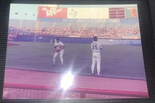 Baseball game in progress featuring Nolan Ryan with Texas Rangers trading cards