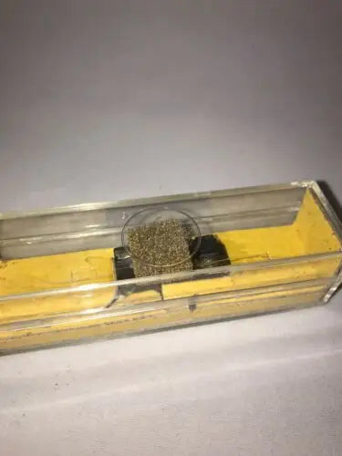 Clear box with a brown bristly object for NOS EV Electro Voice cartridge Sonotone part