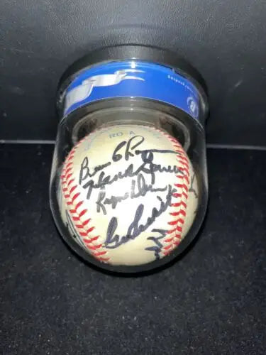 Autographed baseball in clear container featuring Yankees Greats signed by legends