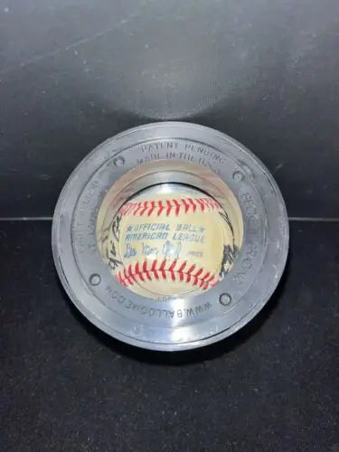 Baseball in a circular display case featuring Yankees Greats signed by legends